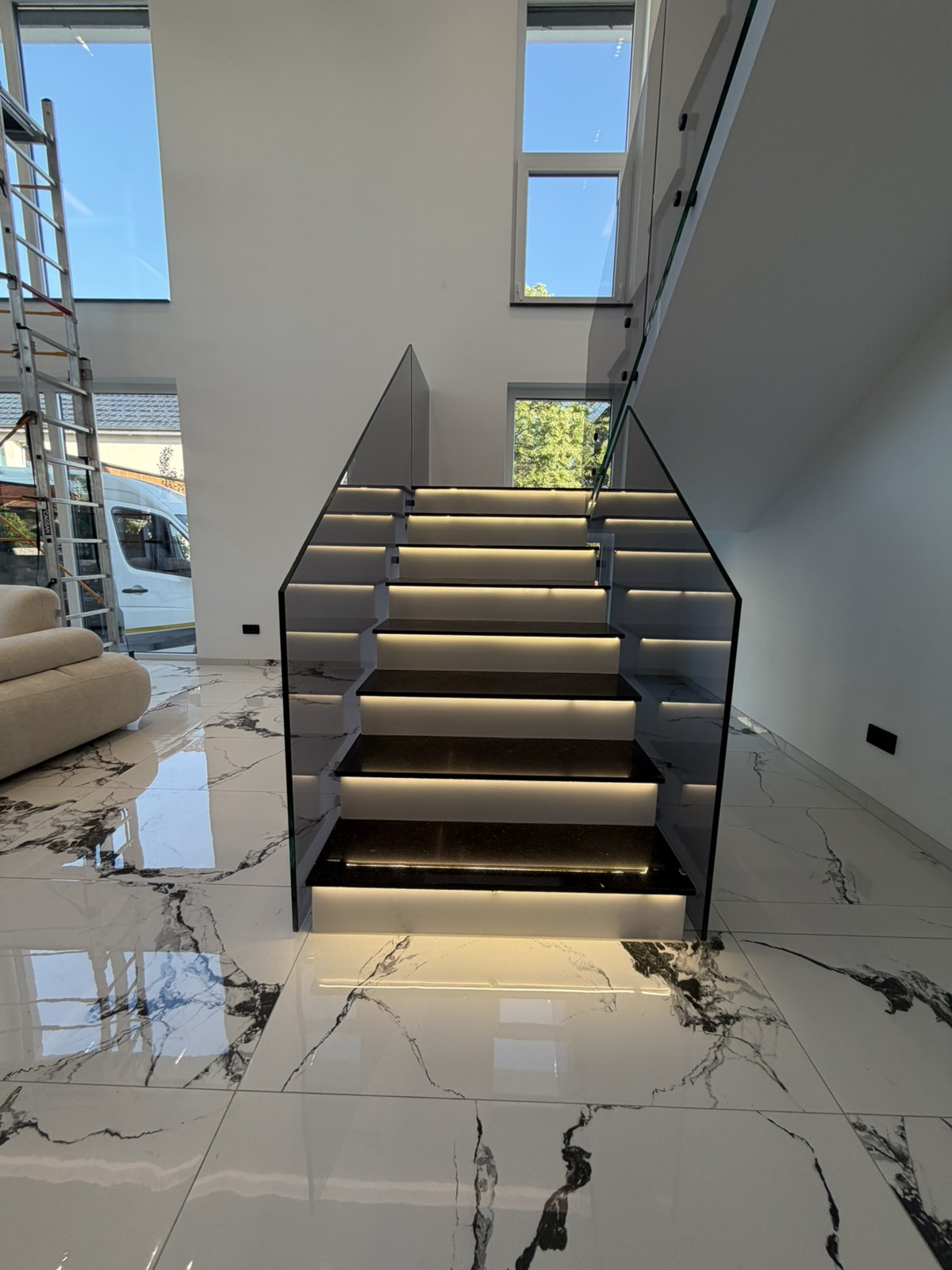 Frameless glass balustrade on an illuminated floating staircase